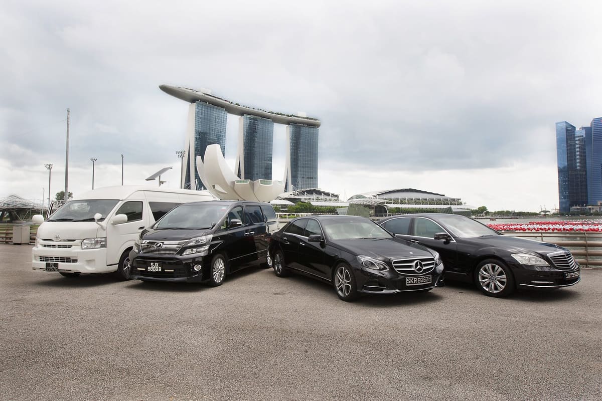 Transfer fleet of sedans and minivans in front of Marina Bay Sands